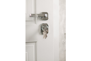 white internal door with silver door furniture and keys hanging out of lock