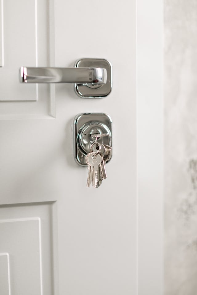 white internal door with silver door furniture and keys hanging out of lock